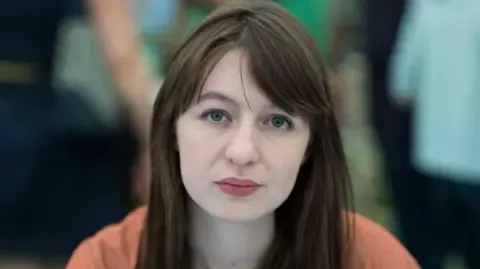 Irish author Sally Rooney claims she is unable to visit the UK due to potential arrest
